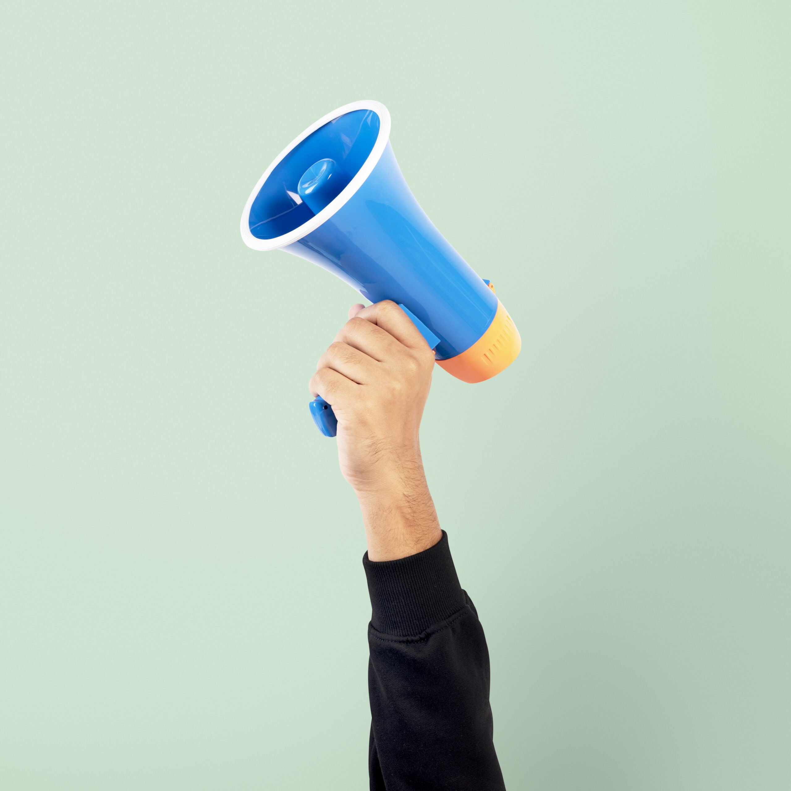 Main tenant un mégaphone bleu - bannière service Gestion PPC Amazon Ads